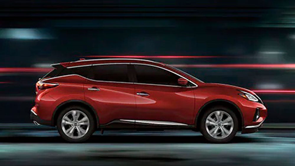2023 Nissan Murano shown in profile driving down a street at night illustrating performance. | Nissan City of Springfield in Springfield NJ